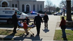 "Emergency response outside Annunciation Catholic School in Minneapolis after a tragic shooting. Police, paramedics, injured children, and anxious parents in a dramatic morning scene with shattered stained glass windows."