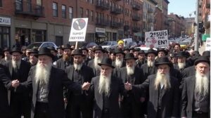 Dozens of rabbis and activists sitting on Brooklyn Bridge during Rabbis for Ceasefire protest, October 2025, demanding a ceasefire in Gaza. 